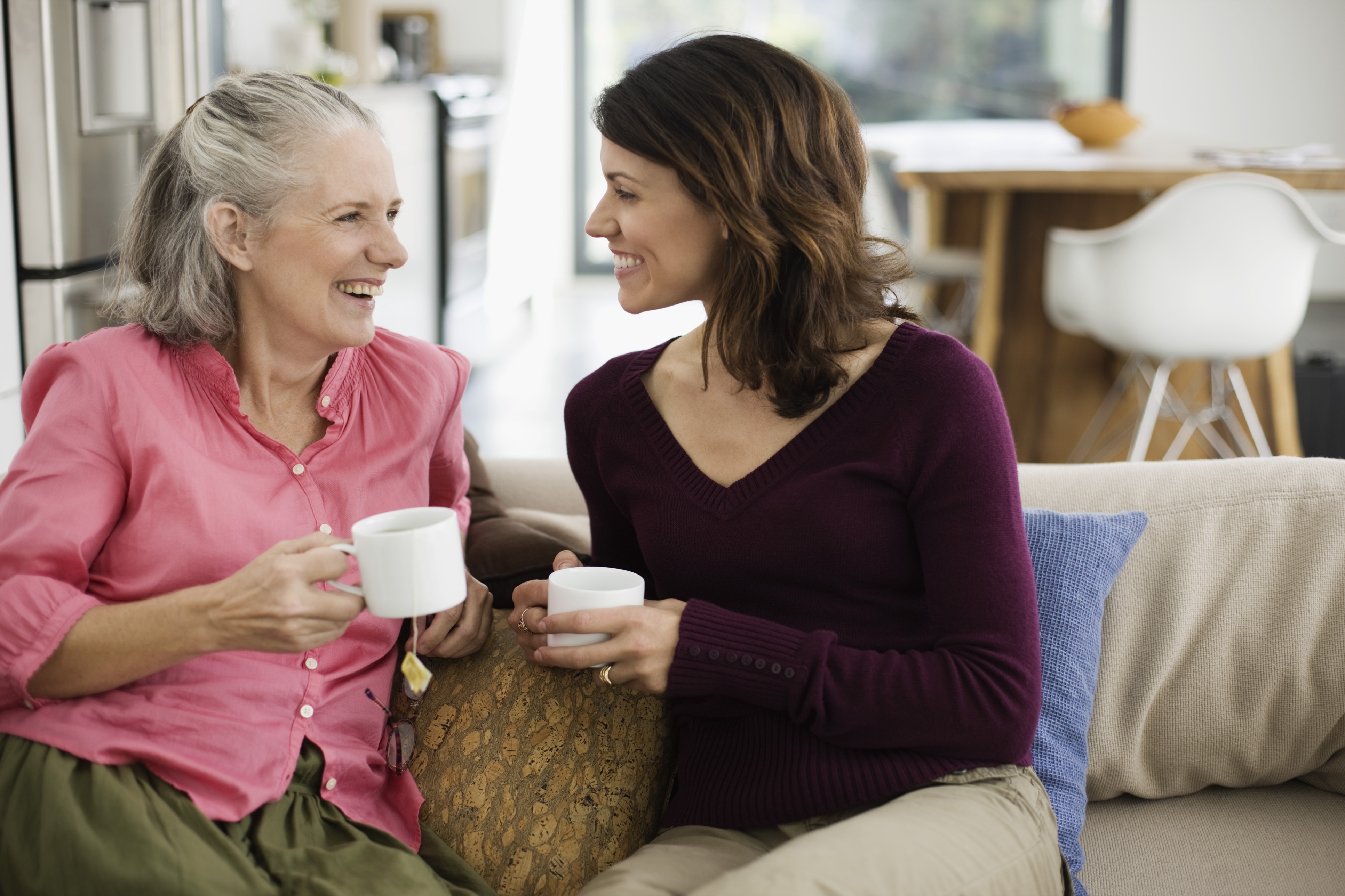 Older adult and daughter drinking coffee