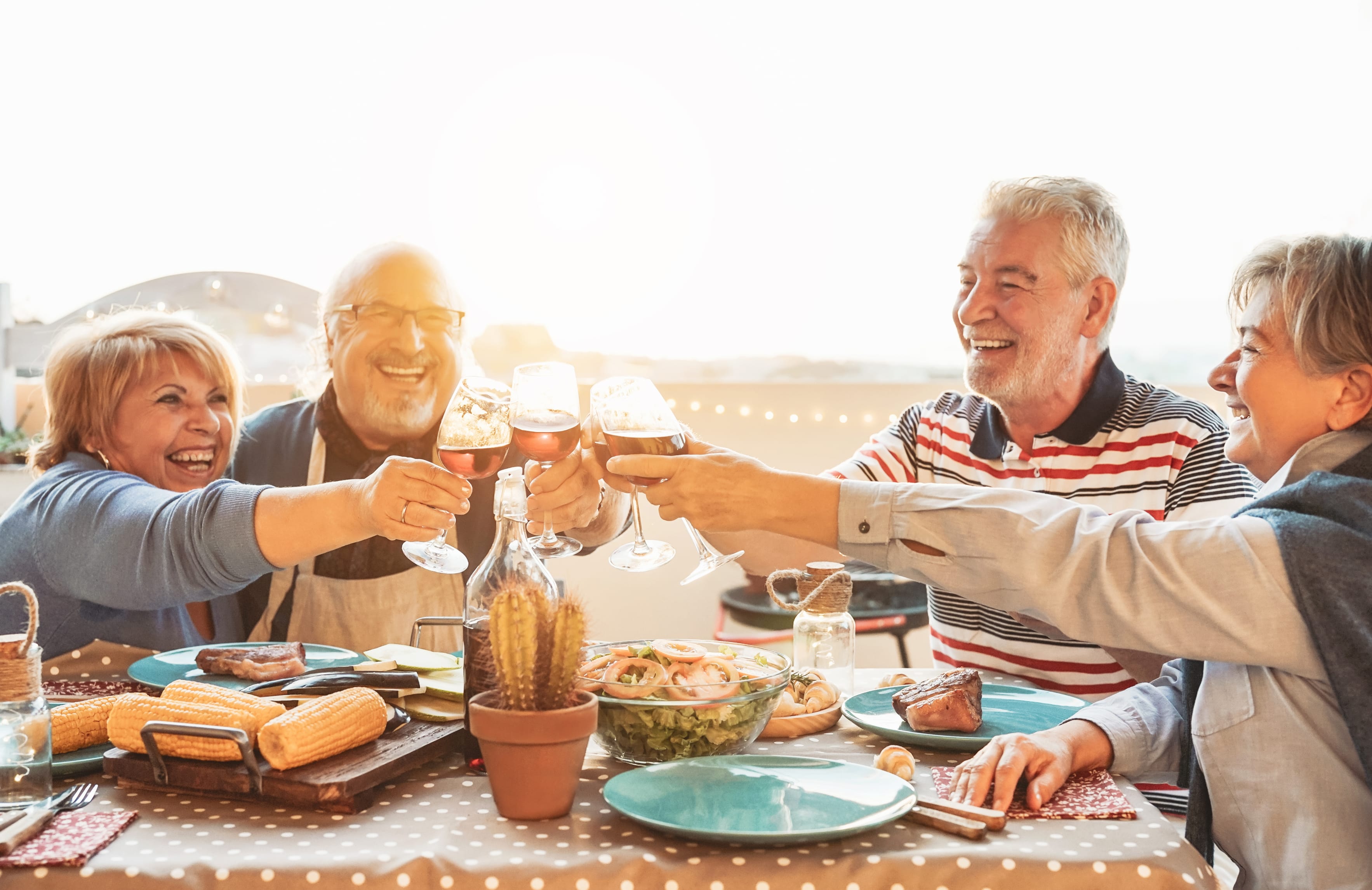 Seniors toasting, eating outside together
