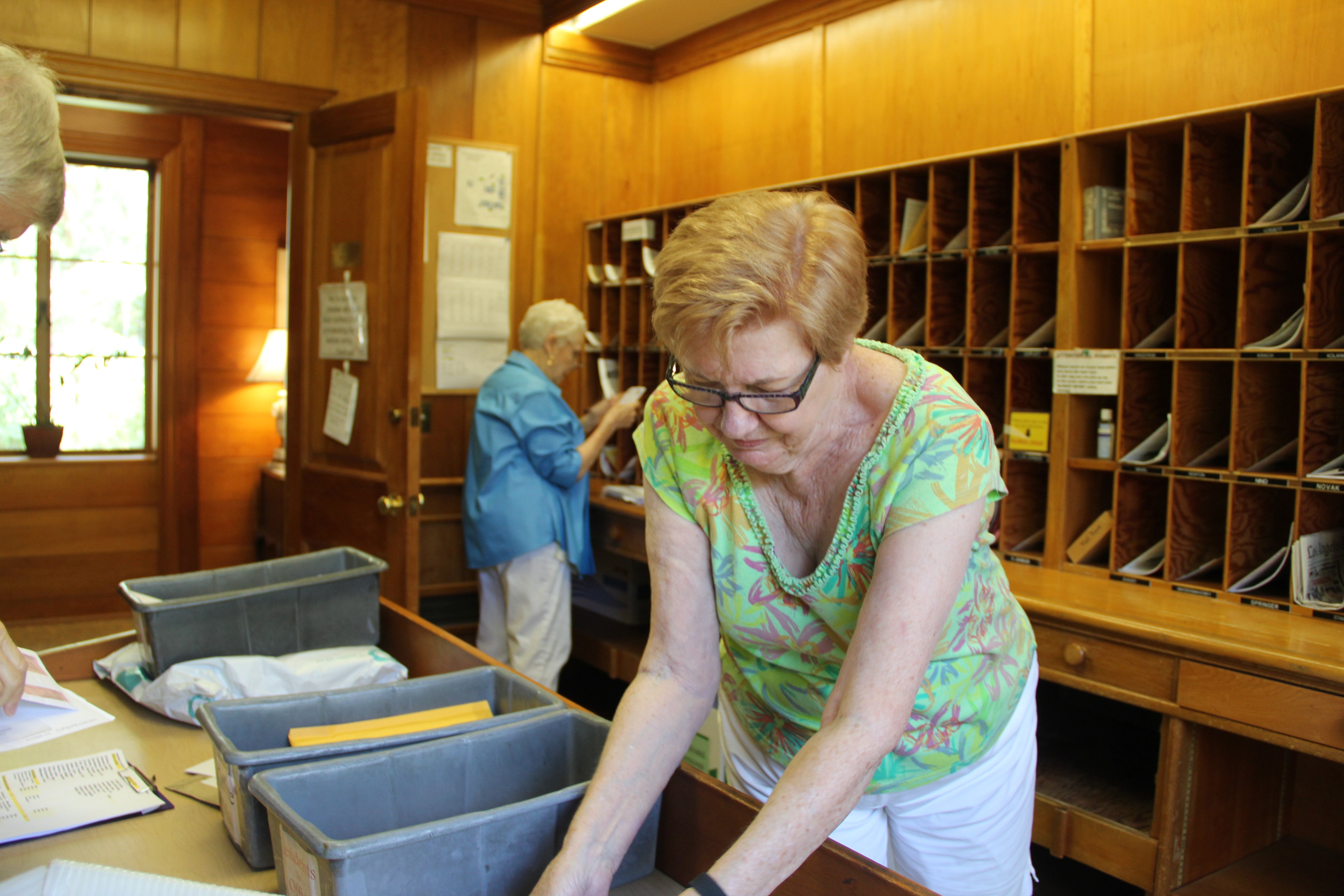 Older women sorting mail at senior living community