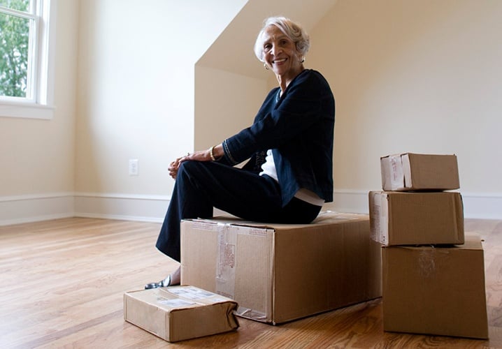 Older woman sitting on boxes